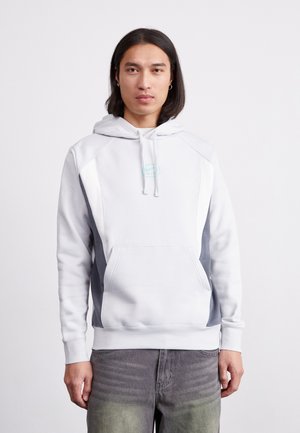 Light gray hoodie with darker gray side panels, kangaroo pocket, and adjustable drawstring hood. Features a small blue logo on the chest.