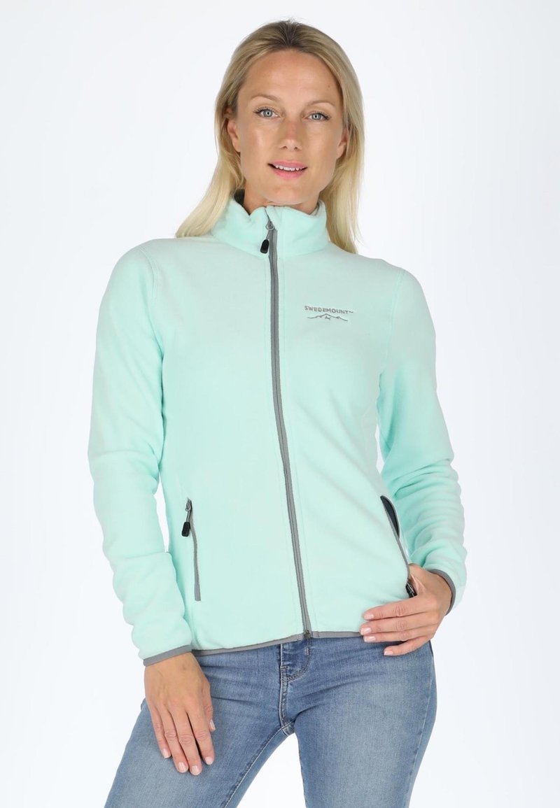 Light teal fleece jacket with a high collar, front zipper, and side pockets. Features grey accents along the zipper and cuffs.