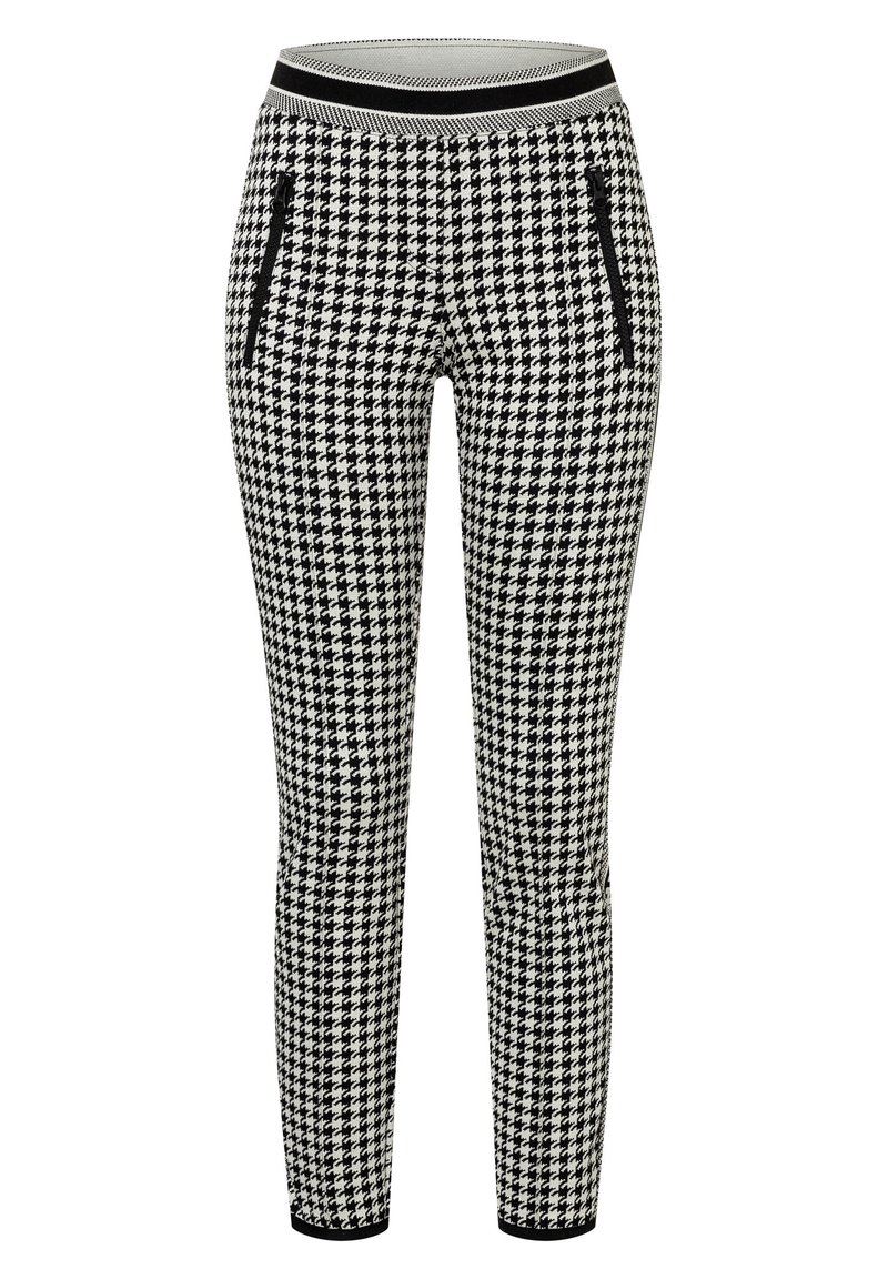 Schackrutiga leggings i svart och vitt med ett tjockt svart midjeband och två fickor med dragkedja på sidorna. Stretchigt tyg för komfort.