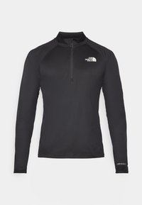 Zwarte lange mouw actieve top met een kwart-ritssluiting kraag, textuurstof, zijnaadzakken en een subtiel logo op de borst.