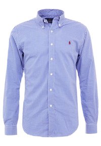 Camicia a maniche lunghe a quadri blu e bianchi con colletto a punta e logo ricamato sul petto. Realizzata in tessuto di cotone intrecciato.
