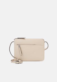 Beige crossbody bag made of textured material. Features a zip closure, front pocket, and adjustable strap with silver-tone hardware.