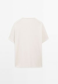 Cream-colored, short-sleeved t-shirt made of soft fabric. Features a crew neck and a relaxed fit, with no visible patterns or accents.