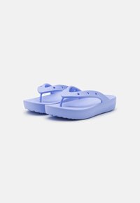 Infradito viola realizzati in materiale morbido e flessibile, con una soletta testurizzata, sottili cinghie e una suola piatta con scanalature decorative.