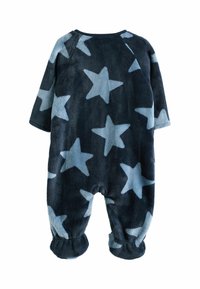 Fleece-yksiosainen asu tummansinisellä pohjalla ja vaaleansinisellä tähtikuviolla. Varustettu pitkillä hihoilla ja joustavilla nilkkakudoksilla. Pehmeä rakenne.