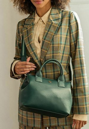 Green textured leather handbag with dual top handles and a removable shoulder strap, featuring a circular logo accent on the front.