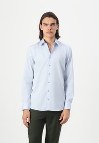 Light blue long-sleeve shirt made of smooth fabric, featuring a button-up design, pointed collar, and contrasting button details.