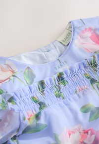 Light blue floral dress with pink roses, gathered elastic detail below the neckline, and a visible Baker by Ted Baker label.