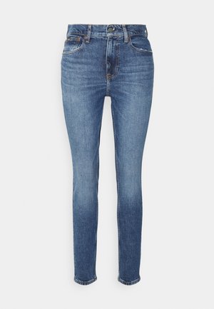 Siniset korkeavyötäröiset kapeat farkut, joissa edessä napit ja vetoketju, viisi taskua sekä hieman haalistunut farkkukuvio.