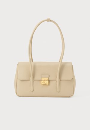 Beige leren handtas met lange bandjes en een vergulde vierkante sluiting aan de voorkant, weergegeven tegen een witte achtergrond.