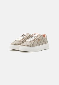 Beige patterned sneakers with a textile upper, white laces, and a thick white rubber sole. Gold-tone eyelets and pink lining detail.