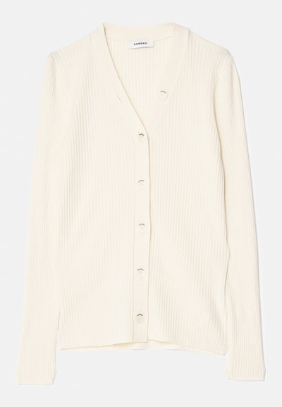 Krēmīgi ribots kardigāns ar V veida kaklu, priekšējiem pogām un garām piedurknēm. Audumam ir maiga tekstūra un pieguļoša forma.