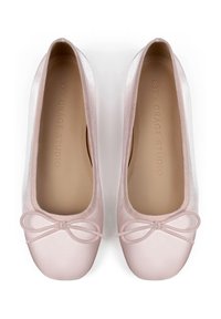 Ballet flats in morbido tessuto rosa con punte arrotondate, dotati di un piccolo fiocco decorativo nella parte anteriore e di una fodera interna liscia.