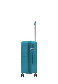 Valigia rigida di colore turchese brillante, con superficie textured, manico telescopico e quattro ruote nere per la mobilità.