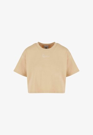 T-shirt beige coupé, fabriqué en coton doux, avec un col rond et des manches courtes. L'avant présente un discret logo blanc.