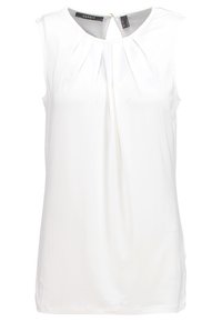 Blouse blanche sans manches avec col rond, plis à l'avant et petite fermeture éclair au niveau du col arrière.