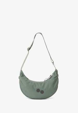 Grüne Nylon-Schultertasche mit geschwungener Form, verstellbarem Trageriemen und zwei schwarzen runden Akzenten auf der Vorderseite. Glatte Textur.