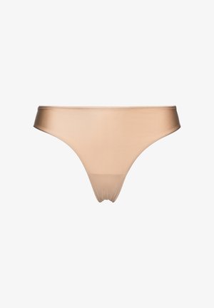 Nude naadloze string gemaakt van gladde, rekbare stof. Heeft een laag uitgesneden ontwerp met minimale bedekking en geen zichtbare naden.
