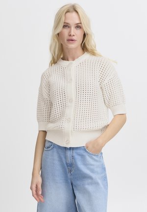 Cardigan a maglia crema con una trama ad open weave, scollatura rotonda e chiusura con bottoni. Presenta maniche corte e orlo a costine.