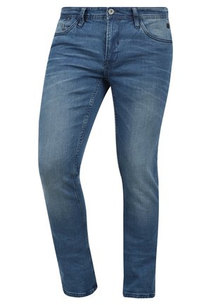 Jeans de denim azul ajustados con un lavado desgastado, diseño de cinco bolsillos y cierre de botón metálico. La tela presenta una ligera textura y detalles de costura.