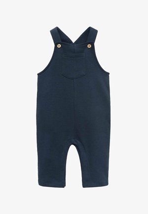 Navy modri bombažni kombinezon z sprednjim žepom, nastavljivimi naramnicami in lesenimi gumbi. Kratke hlačnice z okroglimi odprtinami.