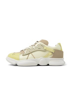 Lace-up sneaker with a yellow and beige color scheme. Features a breathable mesh upper, padded collar, and thick white rubber sole.