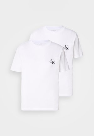 Two white cotton t-shirts with crew necks, featuring a small black "CK" logo on the left chest area. Soft texture, standard fit.