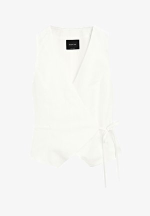 White sleeveless wrap top featuring a deep V-neck, side tie, and subtle texture, with a black brand label inside the neckline.