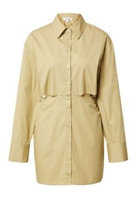 Chemise à manches longues boutonnée couleur beige clair, avec un design superposé court, col et une texture en coton lisse.