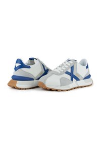 Men's athletic shoes featuring a mesh upper in white, gray suede accents, blue details, and a rubber sole with a textured finish.