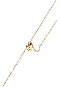Gold chain bracelet featuring a delicate link design, a small round charm with an initial, and a slender stick closure.