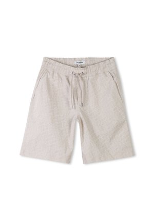 Shorts de couleur beige clair avec une taille élastique et un cordon de serrage. Motif géométrique blanc remarquable sur le tissu. Texture lisse.