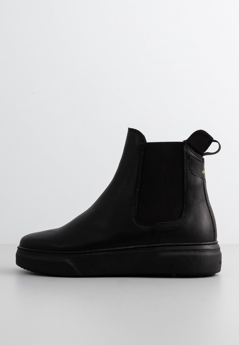 Bottes Chelsea en cuir noir avec panneaux latéraux élastiques, bout arrondi et languette à tirer. Texture lisse et semelle en caoutchouc pour adhérence et confort.