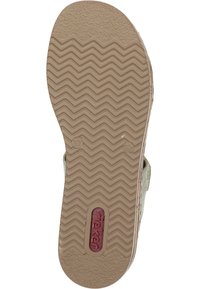 Brown rubber sole with zigzag tread pattern, featuring a logo. Shoes have a light olive green upper material visible at the edges.