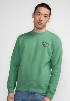 Green sweatshirt with crew neckline, ribbed cuffs, and hem. Features a logo printed on the upper left chest. Soft fabric texture.