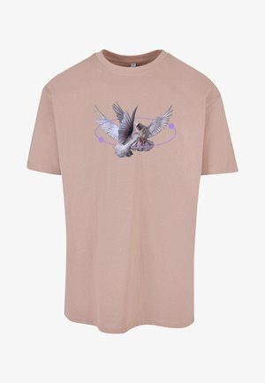 Heledane roosa puuvillane T-särk, millel on graafika avatud tiibadega linnust, ümber mille on lilla ringikujuline disain.