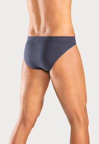 Dunkelblaue Bikiniunterhosen mit glatter Textur, niedrigem Schnitt, elastischem Bund und minimalistischem Design.