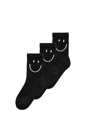 Drei schwarze Crew-Socken mit weißen Smiley-Gesichtern auf der oberen Vorderseite, überlappend auf weißem Hintergrund angeordnet.