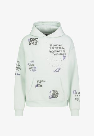 Weißer Kapuzenpullover mit motivierendem schwarzem und lila Text sowie Symbolen, darunter "GIB NICHT AUF", Herzen und Sterne.