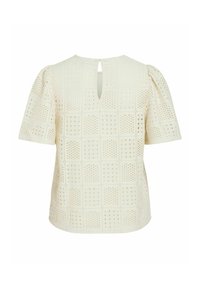Krämfärgad blus med korta ärmar, puffärmar och fyrkantigt öggelmönster, med en liten nyckelhålsöppning i ryggen med knappstängning.
