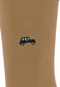 Calzino di cotone beige con texture a coste, caratterizzato da un piccolo design di un'auto ricamato in nero.