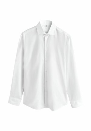 Ilgas baltas marškiniai su ilgomis rankovėmis, pagaminti iš lygaus audinio, turi klasikinį apykaklę, priekinius mygtukus ir išlenktą apatinę kraštą. Be raštų ar akcentų.