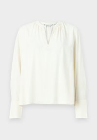 Kremfarget bluse med lange ermer i et lett stoff, med V-hals, innsamlede detaljer på skuldrene og rett nederkant med knappede mansjetter.