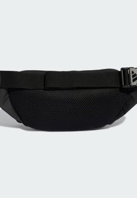 Black fanny pack with mesh fabric on the front, a solid back, adjustable strap, and plastic buckle. Compact oval shape for storage.