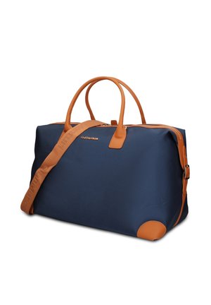 Marineblauwe reisttas met bruine leren handvatten, hoekbeschermers en verstelbare schouderriem met reliëf branding.