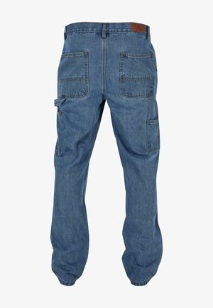 Középkék vászon cargo nadrág, több zsebbel, laza szabással és rugalmas mandzsettával a bokáknál, bőrövet is tartalmaz a deréknál.