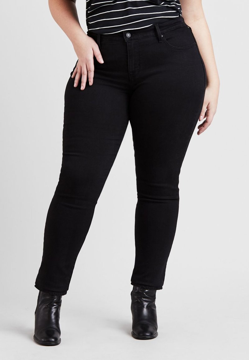 Svarte smale jeans laget av denim, med klassisk fem-lomme design, middels høyde livlinje, og en glatt, strukturert finish.