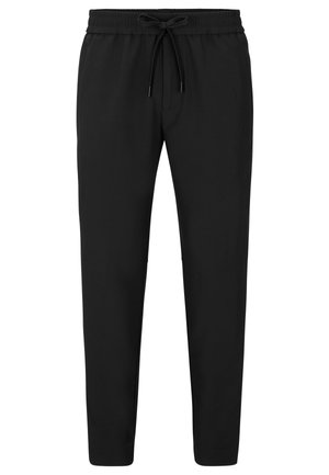 Svarte joggebukser med elastisk midje og snor, smale ben og en myk tekstur. Ingen synlige mønstre eller accenter.