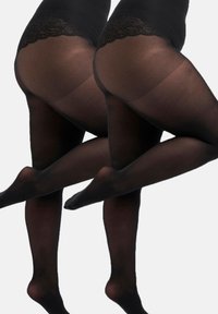 Collants opaques noirs avec une ceinture en dentelle texturée. Les collants ont une finition lisse et sont présentés sur des jambes croisées, mettant en valeur leur ajustement.