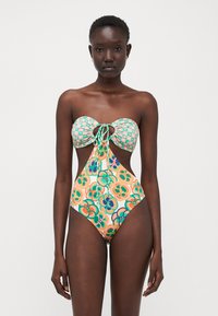 Maillot de bain une pièce coloré avec un haut bandeau, motif floral, côtés découpés et fermeture à nouer à l'avant. Fabriqué en tissu lisse et extensible.